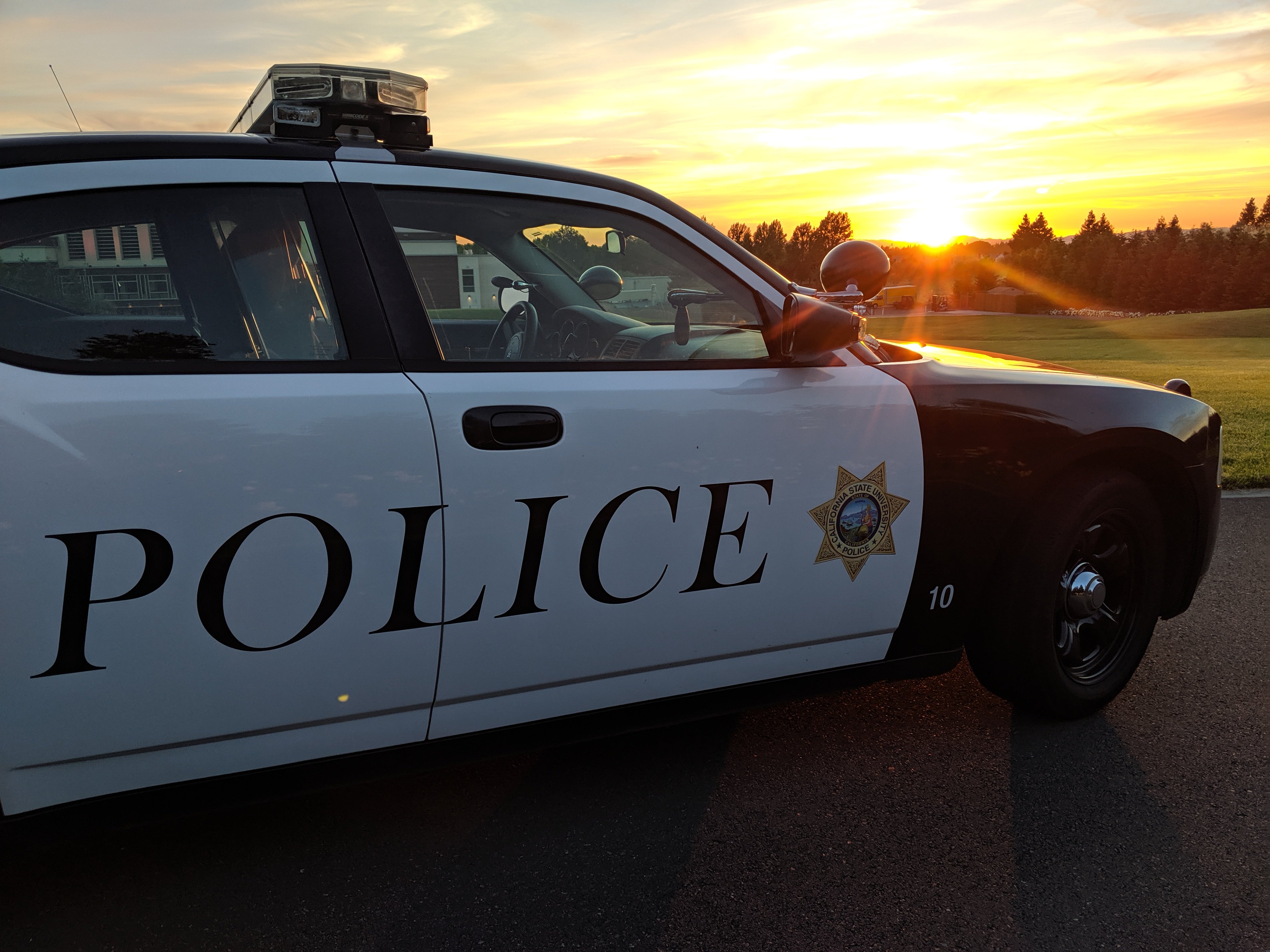 patrol car over sunset