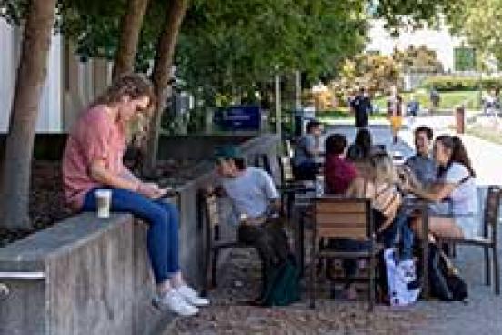 GRoup on people around an outside table.  